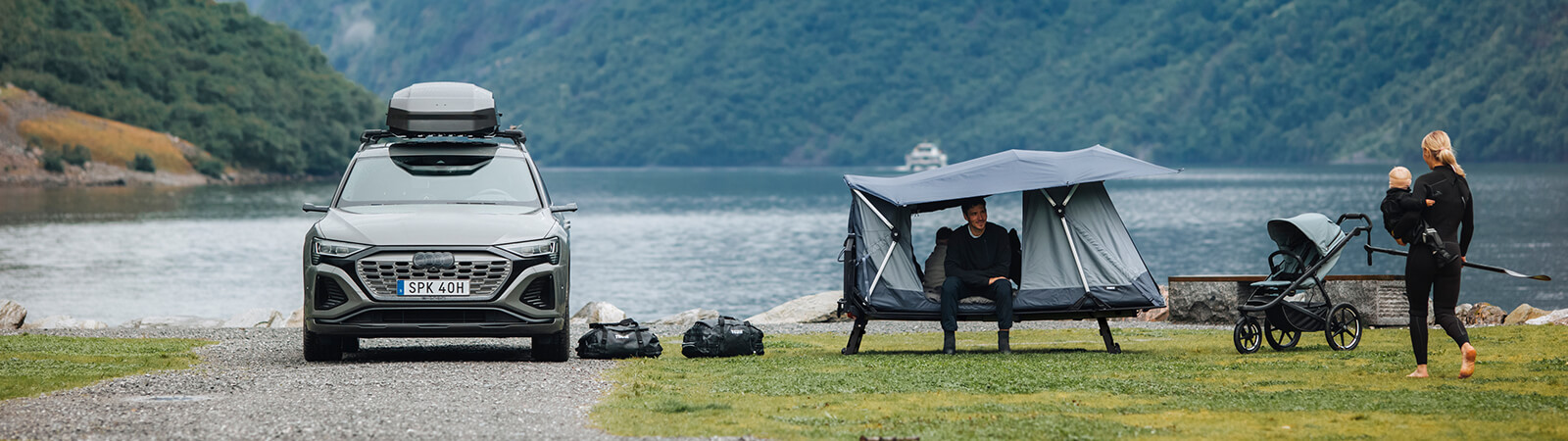 A family set-up camp with their towbar tent detatched from their car