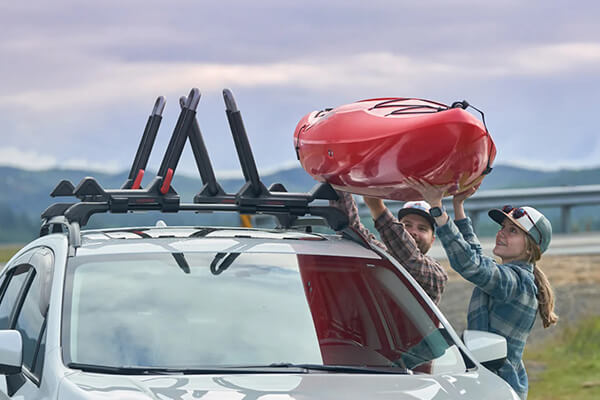 Couple load a kayak into their Yakima water sports rack